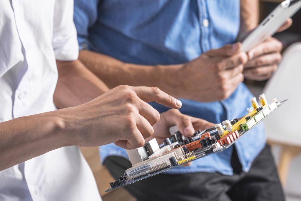 close up male technician pointing motherboard
